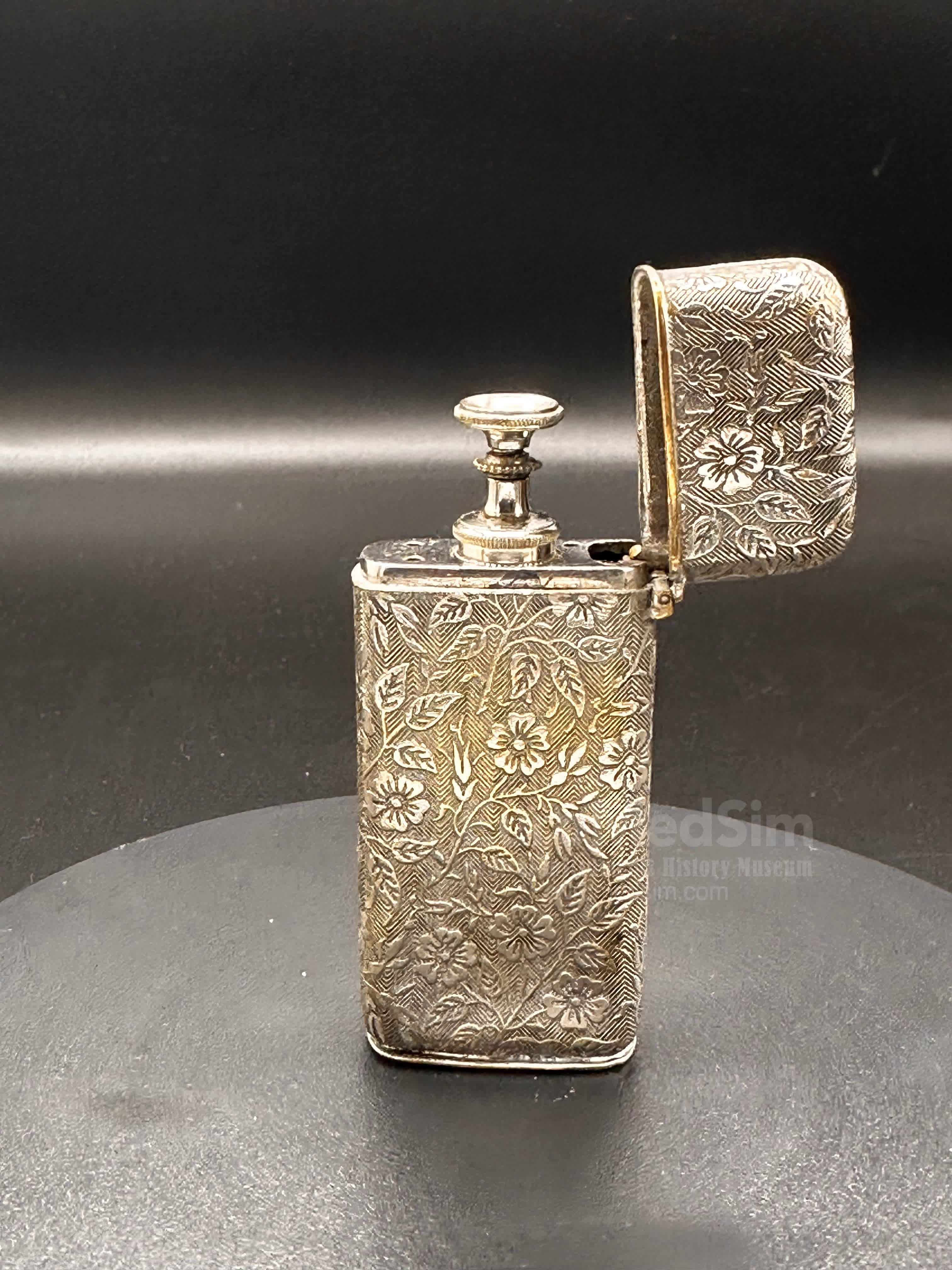 Hypodermic Pravaz syringe in a rich floral ornamented metal case with an inscription on the bottom "T.A.M. Ear & Throat Class. 1901"