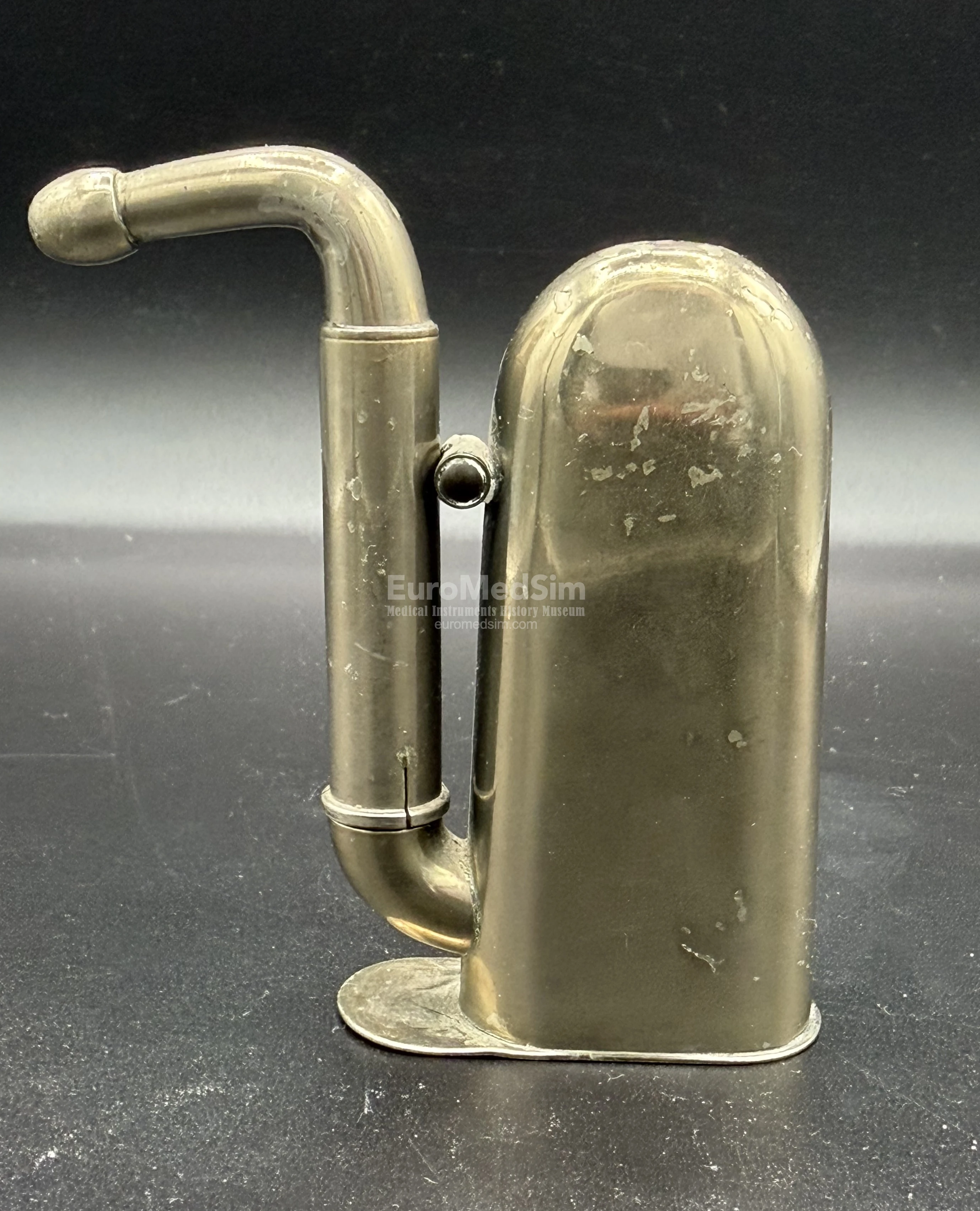 A nickel-plated brass Hawksley-type hearing aid in a compact, folded state. England, c.1880.