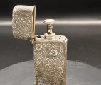 Hypodermic Pravaz syringe in a rich floral ornamented metal case with an inscription on the bottom "T.A.M. Ear & Throat Class. 1901"