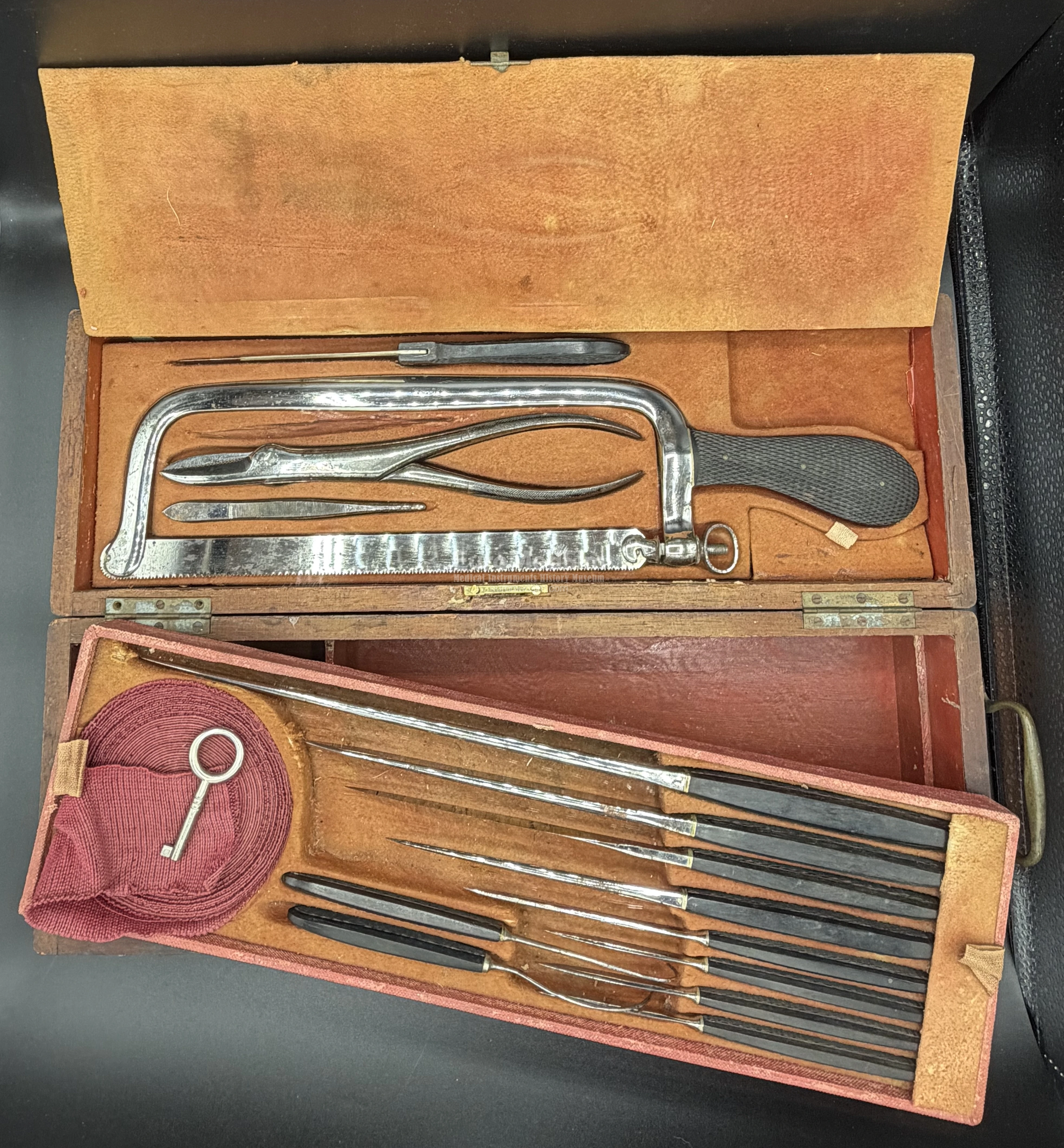 Lower compartment is opened. Amputation saws, pliers, knives and needles in the surgical cased set by Charriére á Paris/COLLIN & Cie, France, end of XIX c.