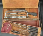 Lower compartment is opened. Amputation saws, pliers, knives and needles in the surgical cased set by Charriére á Paris/COLLIN & Cie, France, end of XIX c.
