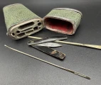 The original content of the case is not presented and etui is filled now with several later instruments: a lancet with handle made of brown horn, a spoon-probe and blunt needle with an eye.  The pocket green-stained shagreen case, English, ca. 1800