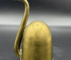 The U-shaped hearing tube extends from the focal point inside the bell, curves outward through the bell's opening, and returns to the ear. This design provides a compact size. England, c. 1880.