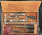 Lower compartment is opened. Amputation saws, pliers, knives and needles in the surgical cased set by Charriére á Paris/COLLIN & Cie, France, end of XIX c.