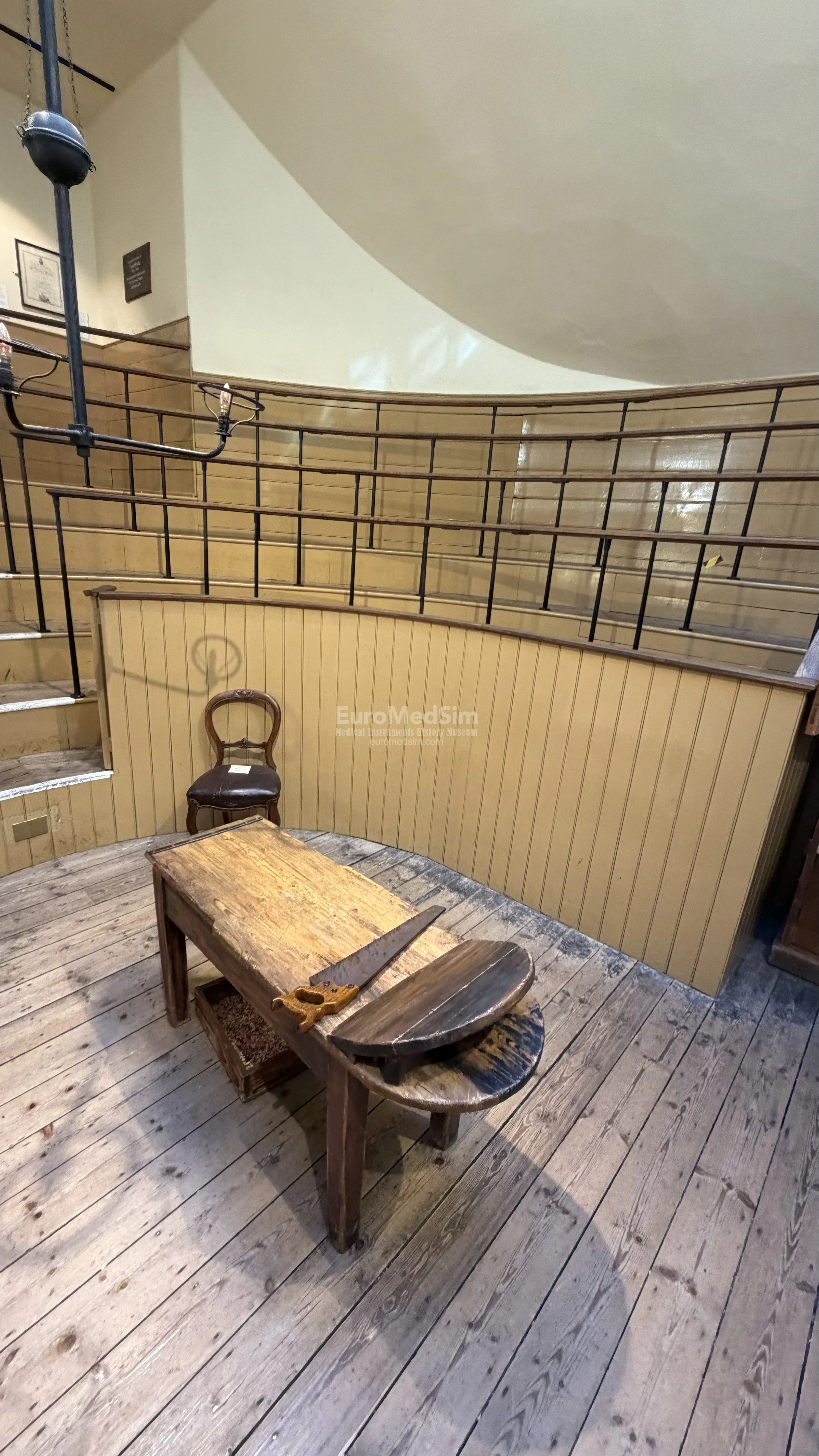 A simple wooden operating table stands in the center of the operating room's “stage.” Added to the drama, a large saw (though not a working one—for the safety of visitors) is screwed to it.