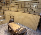 A simple wooden operating table stands in the center of the operating room's “stage.” Added to the drama, a large saw (though not a working one—for the safety of visitors) is screwed to it.