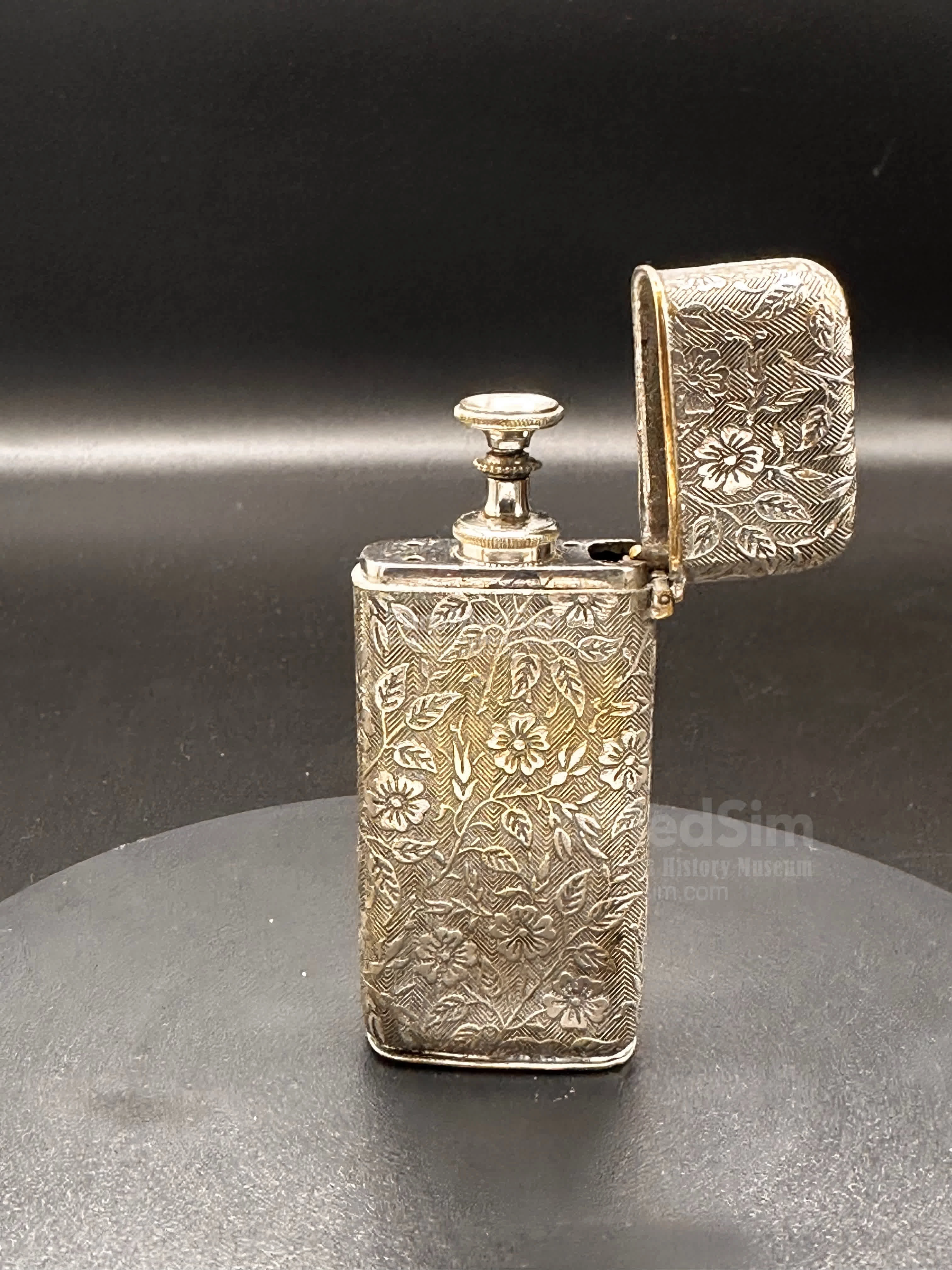 Hypodermic Pravaz syringe in a rich floral ornamented metal case with an inscription on the bottom "T.A.M. Ear & Throat Class. 1901"